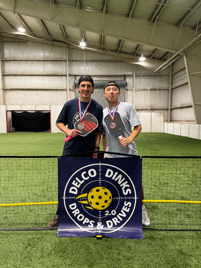 Matt Ryan with a player behind a pickleball net